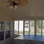 large ceiling fan and hot tub installed inside sun room