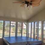 large ceiling fan and hot tub installed inside sun room
