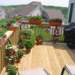 custom deck installed in backyard with potted plants