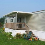 small white roof built over front porch on mobile home