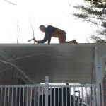home improvement contractor working on top of roof