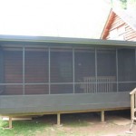 custom black three season room built attached to log house